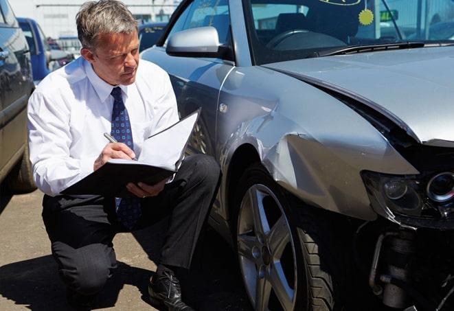 person holding auto insurance policy paperwork